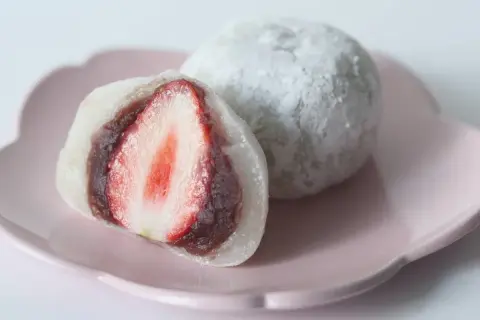 Słodkie mochi co to? Delikatne ciastko ryżowe z nadzieniem z pasty fasolowej i soczystą truskawką w środku.