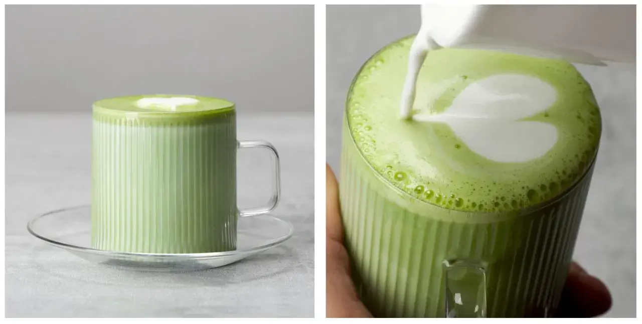 Zielone matcha z mlekiem w szklance z uchwytem, z pianką w kształcie serca.